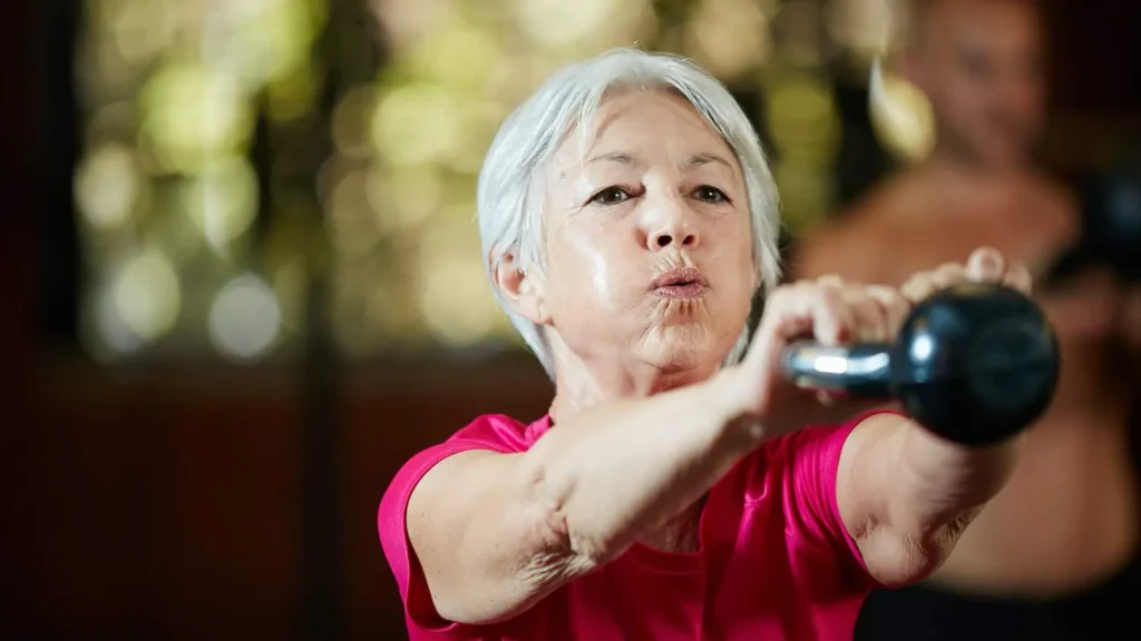 Toning Bingo Wings: Effective Exercises and Tips for Achieving Sleeker Arms 2 Person performing arm exercises with dumbbells Watford